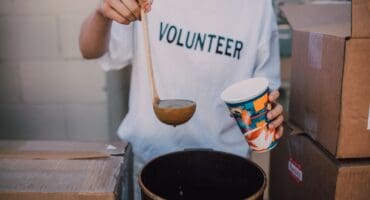For illustrative purposes: A volunteer serves a hot meal. Photo: Pexels