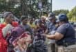 Officials from the Cross Border Transport Inspectorate check the documentation of migrants ahead of boarding buses leaving for Malawi at Sherwood Park in Durban. Photo: RAJESH JANTILAL / AFP