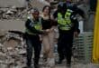 Municipal police officers evacuate an injured victim from a collapsed building following an earthquake in Caracas on June 24, 2026.