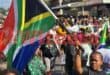 A woman who is taking part in the protest organised by March and March holds up the South African flag. Photo: Moeketsi Mamane