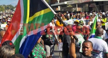 A woman who is taking part in the protest organised by March and March holds up the South African flag. Photo: Moeketsi Mamane