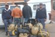 Two police officers stand with the men arrested for dealing in dagga after multiple bags were found in their wrecked VW polo. Photo: SAPS Facebook