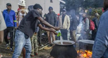 A volunteer pours milk to make tea for displaced foreign nationals, who have taken refuge in a park in Durban yesterday, after fleeing their homes amid fears of xenophobic attacks. Hundreds of foreign nationals await repatriation to Malawi from South Africa following xenophobic violence in the country. Foreign nationals have told of intimidation and beatings by mobs going door-to-door to tell them to leave by June 30, a ‘deadline’ regularly broadcast across social media, even though it has no official backing. Ghana, Mozambique and Malawi are among countries that have repatriated hundreds of their nationals this month. Photo: RAJESH JANTILAL