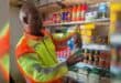 Mfolozi Mayor Xolani Bhengu inspects a longlife milk bottle to ensure it has not gone passed its expiry date. Photo: Supplied