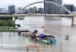 Flooded shops along a submerged riverside walk are seen by the overflowing Yongjiang river in Nanning, in China’s southern Guangxi region on July 7, 2026.