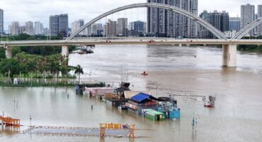 Flooded shops along a submerged riverside walk are seen by the overflowing Yongjiang river in Nanning, in China’s southern Guangxi region on July 7, 2026.