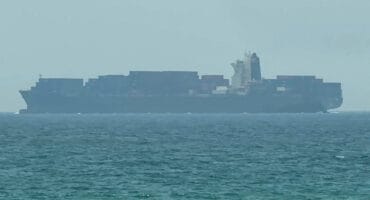 This frame grab taken from AFPTV video footage on July 12, 2026 shows a cargo ship anchoring near the Strait of Hormuz off the eastern coast of the United Arab Emirates at Khor Fakkan.