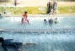 Children cool off in a public water playground at a park in Edogawa district of Tokyo on July 23, 2026.
