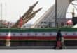 A woman and a child walk past Iranian-made Zolfaghar missiles displayed at Azadi Square in Tehran on July 24, 2026. Photo: AFP