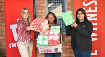 From left: Witness staff members Jade le Roux, Natalie Maphumulo and Ronelle Ambrose with staff contributions for the ‘She Matters’ sanitary pad donation drive. Photo: Moeketsi Mamane