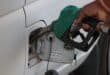 A man places a fuel nozzle into a car. Photo: Pexels
