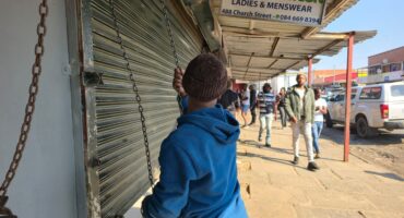 A man closes a business in Pietermaritzburg's CBD on Wednesday ahead of Thursday's planned March and March demonstration targeting businesses allegedly operated by undocumented foreign nationals. Photo: Moeketsi Mamane