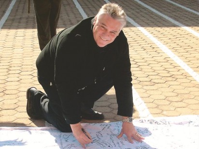 Ivan Baily, principal of Krugersdorp High School writing birthday and get well messages for Madiba.