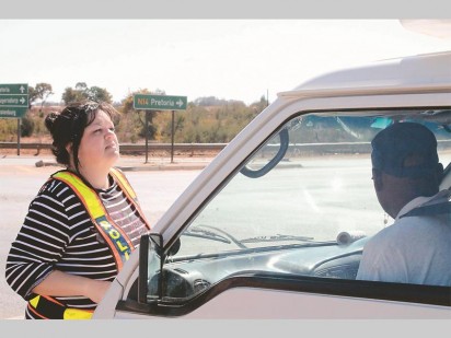 Principal typist Martie Mans checks the to see if the taxi's licence is up to date.