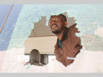 Emmanuel Kulate, a representative from the Greater Krugersdorp Taxi Association inside one of his taxis that was badly damaged when violence broke out between their association's members and members of the Dobsonville Roodepoort Leratong Johannesburg Taxi Association (Dorljota).