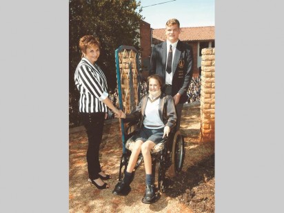 Acting principal of Hoërskool Monument, Gerda Joubert and head boy Ryno Herbst with Stacey Farrell seated in her wheelchair.