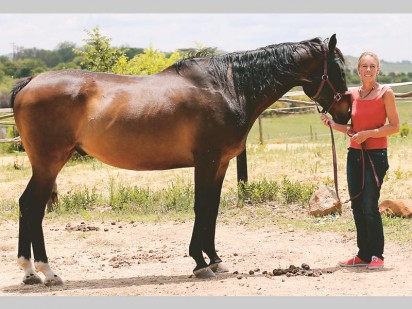 Janice Horsnell with one of the horses used in therapy. She demonstrated how some therapy includes running with a horse. Photo: Martin Elsas.