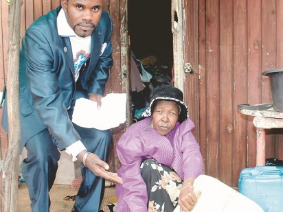 Dr Joseph Katwala Meddy, the ACDP's West Rand Regional Chairperson (left) with Clara Ntsepe (62) a resident of the Soul City informal settlement. She has to carry water cans to and from the communal taps.