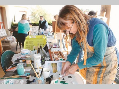 Belinda Milson mixing the paint for her artwork.