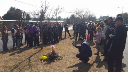 Family members and friends laid down flowers and put up purple balloons to commemorate Rosalind Kruger's life.