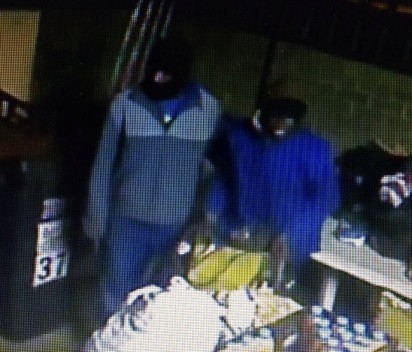 The two masked men caught on CCTV cameras as they enter the house.