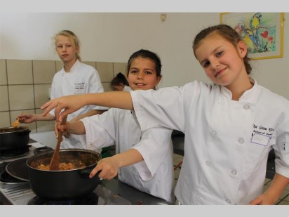 Gabriella Maddin and Cheyan Hambides adding the final touches to their dish.