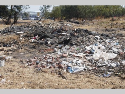 Rubble and other rubbish are seen strewn on the grounds of Coronation Park.