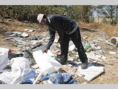 Derrick Williams, a resident at Coronation Park busy looking at the material which allegedly was dumped by a fabric factory in Chamdor.