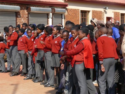 Pupils of Kwaggafontein Primary Farm School eagerly await to be handed a solar powered light.
