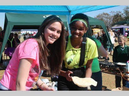 Caitlin Swart en Kathleen Francis besig om 'n pannekoek te bak. Daarna kan klante kies watter vulsel hulle wil hê.