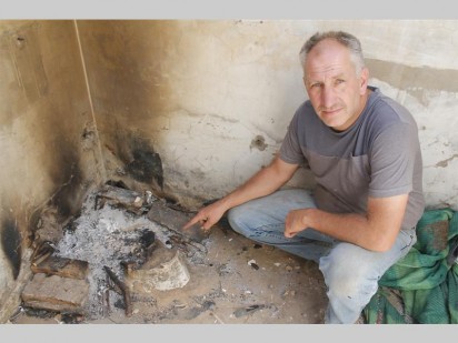 Renier de Beer shows where the current residents cook their food. This used to be the toilet.