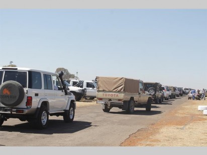 Toyota Land Cruisers getting into the moving convoy.