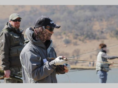 Gary Stevvens waiting patiently for the fish to a bite while reeling in his line.