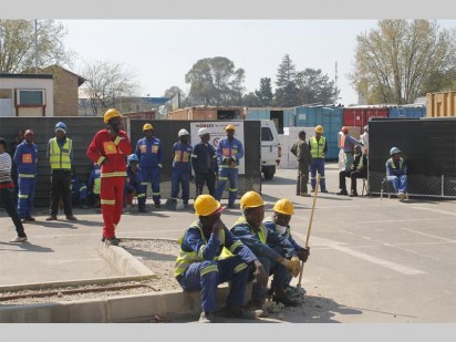 Construction workers waiting to hear when it would be safe to continue with their jobs.