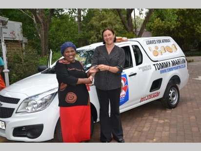 Lise Holloway, marketing manager for Tommy Martin hands over the vehicle to Mama Emily Duda and her team.