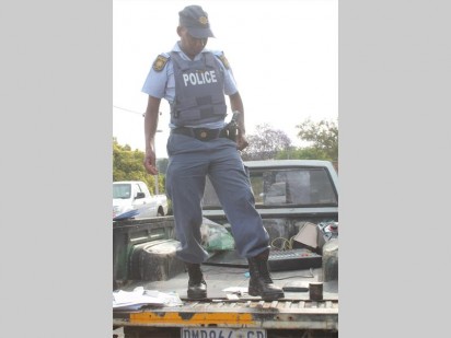 Constable Mans Seleko checks the stolen goods.
