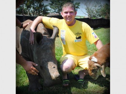 Friend of the rhino Francois Myburgh with Bruiser, an orphaned rhino at the Lion and Rhino Nature Reserve. Photo: Nadia Taljaard-Nilsen/ Phoenix Photographic