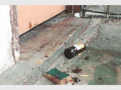 A broken beer bottle and a bloody sponge found at the scene.