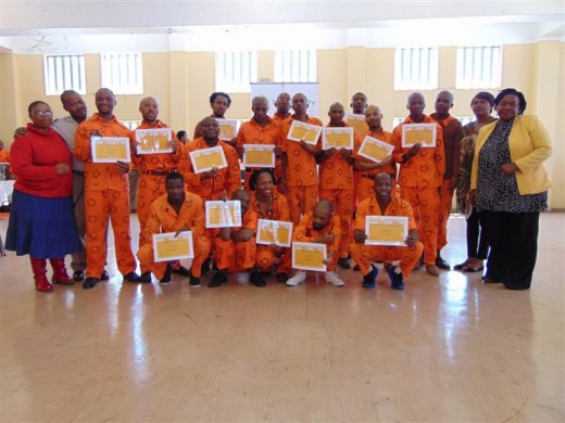 Panel members are seen here with Vincent Maseko (Correctional Centre - Library Services), with the debate participants showing their certificates.