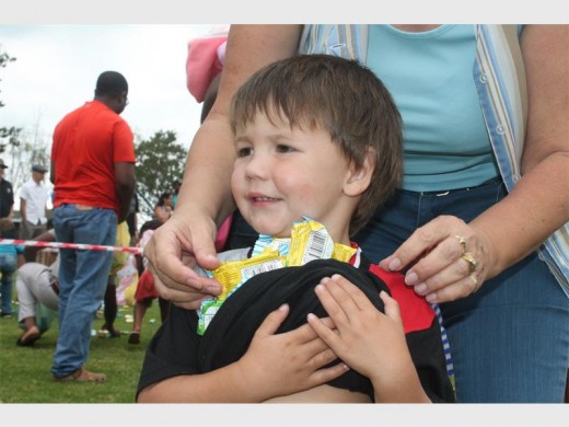 Happy with himself, this youngster holds on tight to his Easter eggs.