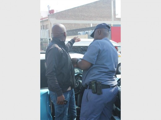 Random searches are conducted in a parking lot opposite a Krugersdorp college.