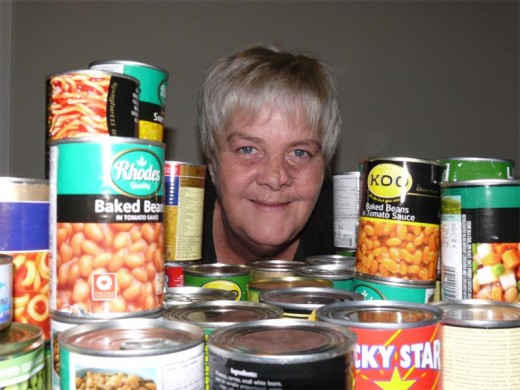 Amanda Verster-Van der Merwe is all smiles about the cans of non-perishable food that the community has given her for the Can-a-Kilo project.