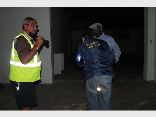 Leon Ehrke, chairperson of the Sector 9 CPF assists police in the search for a suspect.