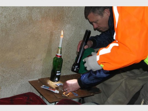 A CPF member along with police raiding a brothel infested with drugs.