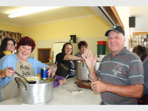 The West Rand Bikers Church's women serve soup with a smile.
