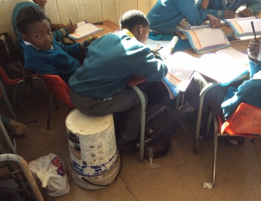 Children are forced to sit on buckets.