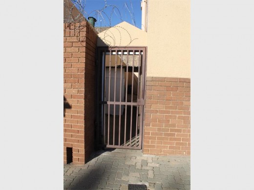 The alley Putter was led into, across the road from the Home Affairs office in Krugersdorp CBD. In this photo, the business was closed, but a sign in front reading 'ID' is usually present.
