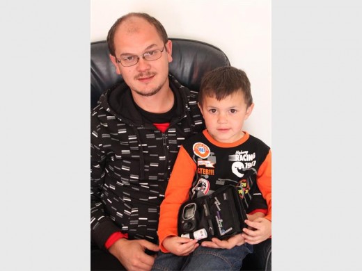 Reuben and his father, Carl along with his sugar level-reading machine.
