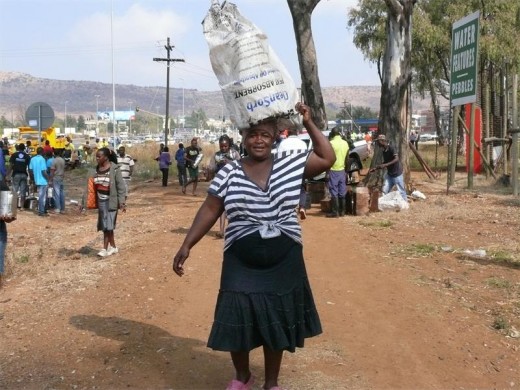 A runaway truck carrying refined vegetable oil from the American humanitarian aid USAID crashed with two vehicles. Nearby residents helped themselves to the 4liter oil cans which tumbled from the truck.