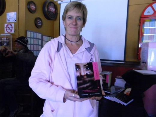From The Pink Ladies, Wendy Skeens holds up the book, Vicky, about a girl who escaped abduction.